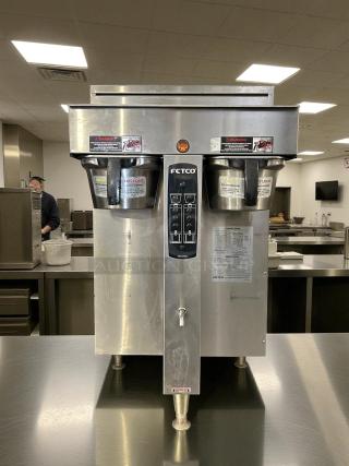 Fetco CBS-2052e twin coffee brewer in great condition, stainless steel, tested, working, with visible control panel and labels.