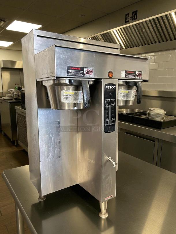 Fetco CBS-2052e Twin Coffee Brewer in great condition, tested and working, stainless steel body, visible warning labels.