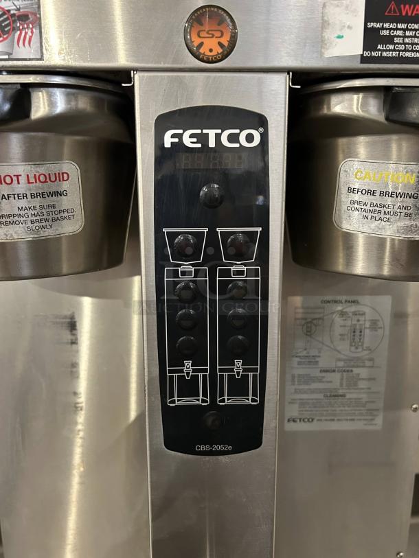 Fetco CBS-2052e Twin Coffee Brewer, stainless steel, tested and working. Includes control panel and safety labels.