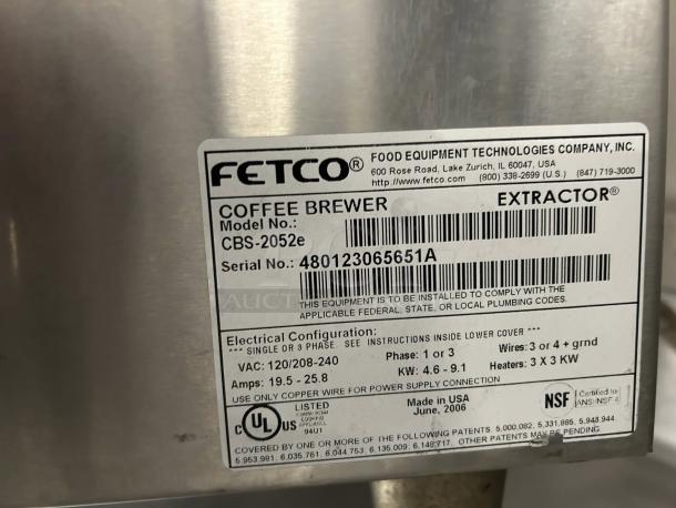 Fetco CBS-2052e twin coffee brewer label showing model, serial number, and electrical specs; tested and working condition.