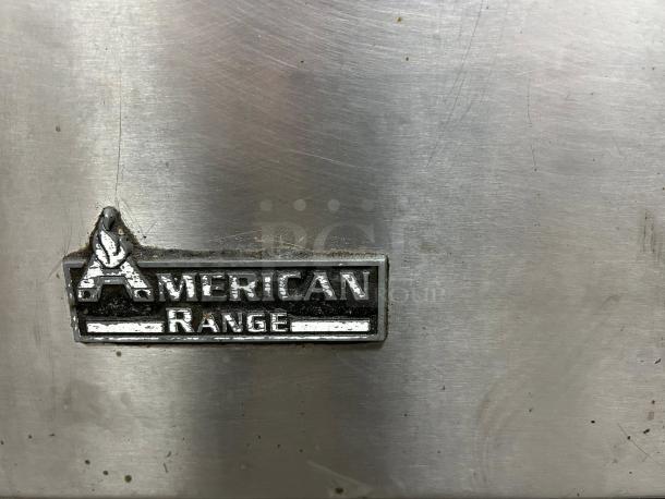American Range AR-6 emblem on stainless steel surface, indicating brand of 36" 6-burner liquid propane range.