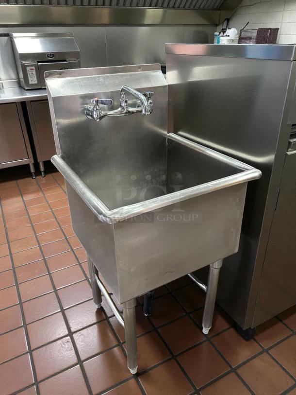 Stainless steel single-compartment sink in great condition, commercial-grade, with faucet and sturdy legs.