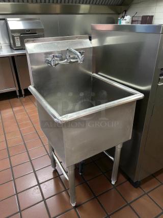 Stainless steel single-compartment sink in great condition, commercial-grade, with faucet and sturdy legs.
