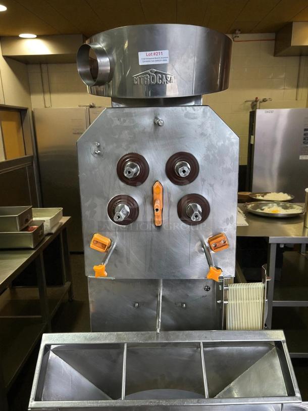 Citrocasa 8000 SB-ATS Advance Citrus Juicer, stainless steel finish, as is. Features brown pressing wheels. Lot #211 tag visible.