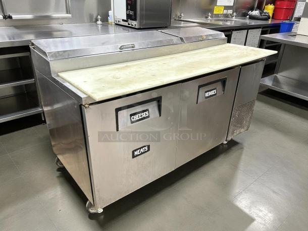 True TPP-AT-67-HC Pizza Prep Table, 67", refrigerated base, great condition, labeled sections for cheeses, veggies, and meats.