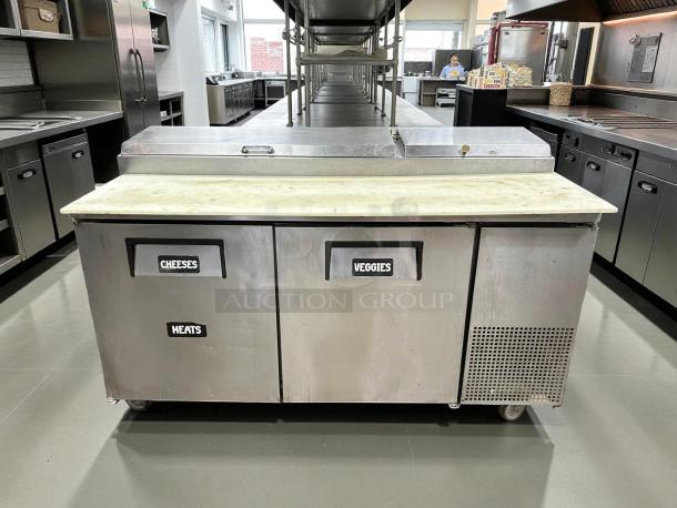 True TPP-AT-67-HC pizza prep table, stainless steel, 67", refrigerated base with labeled compartments, great condition.