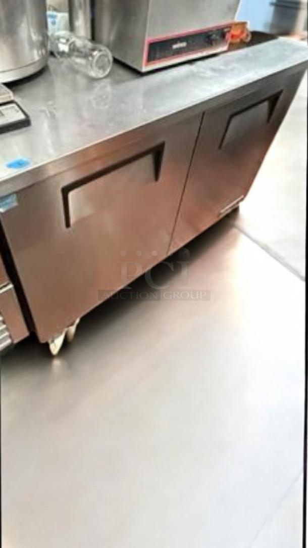 True TWT-48 2-door worktop refrigerator, stainless steel, pristine condition, tested, on casters for easy mobility.