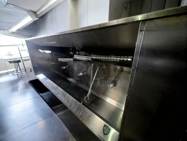 Pristine commercial stainless steel exhaust hood in excellent condition, fully tested and working, features visible ductwork.