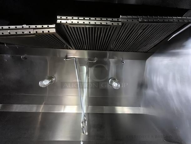 Commercial stainless steel exhaust hood in pristine condition, fully tested and working, with dual light fixtures.