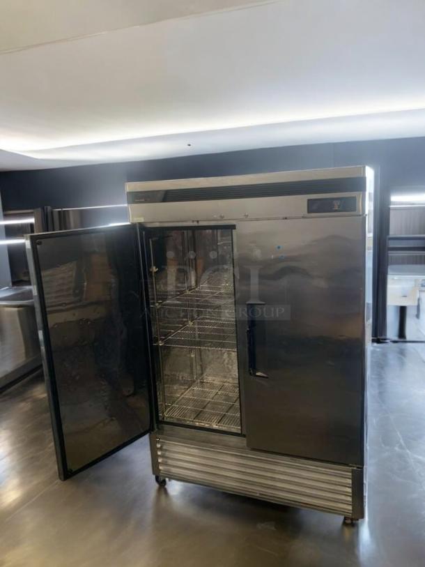 Turbo Air TSF-49SD commercial freezer in prime condition, stainless steel, tested and fully operational, one door open showing wire shelves.