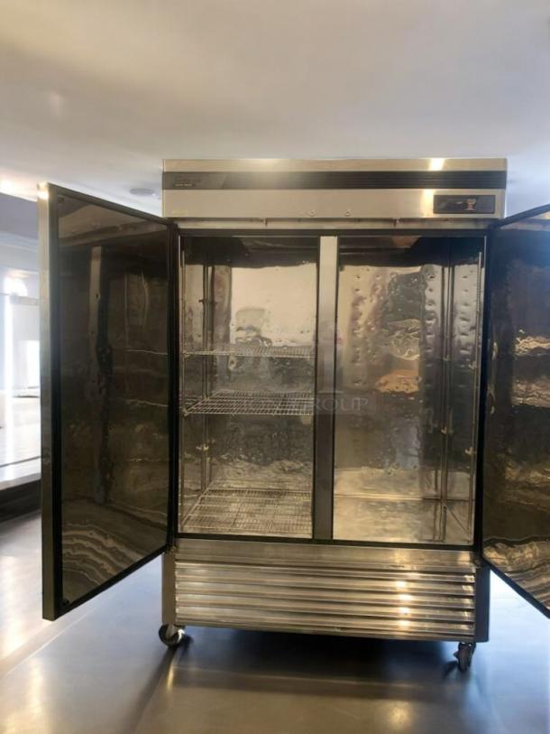 Turbo Air TSF-49SD commercial freezer, stainless steel, prime condition, fully tested, open double doors, wire shelving.