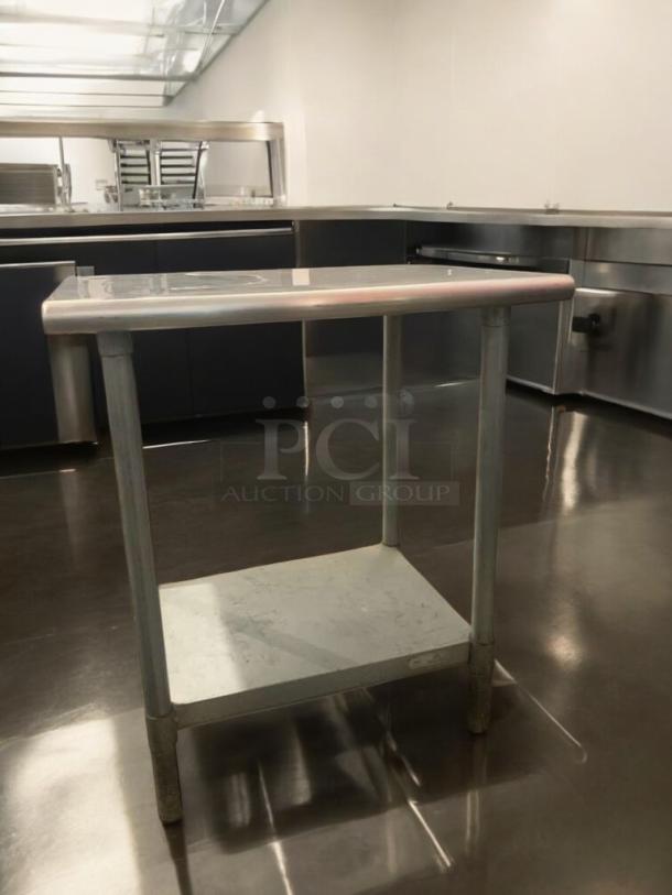 Stainless steel prep table in prime condition, fully tested. Features a sturdy frame and lower shelf. Ideal for commercial kitchens.