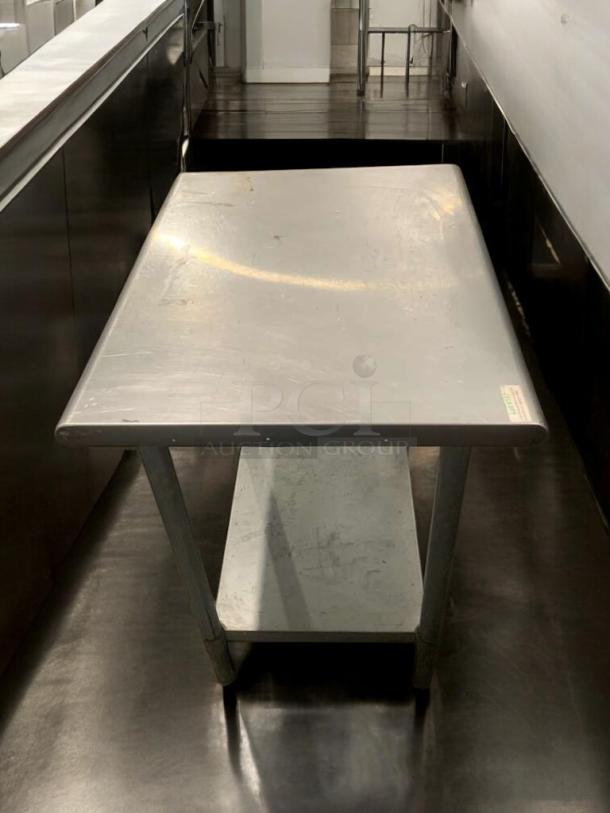 Stainless steel prep table in prime condition, commercial use, fully tested, two-tier design, minor surface marks.