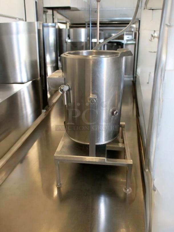 Groen large capacity electric steam kettle, 208V, in prime condition on a stand. Fully tested and working, ideal for commercial use.