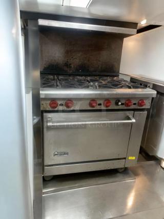 American Range commercial gas range with oven, prime condition, fully tested, stainless steel exterior, six burners, red control knobs.