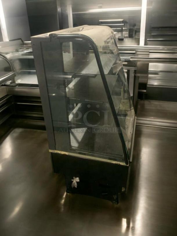 Commercial refrigerated display case, curved glass, multi-shelf, superior condition, fully tested and operational.