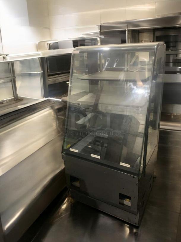 Superior condition refrigerated bakery/deli display case with curved glass, multi-shelf, fully tested and operational.