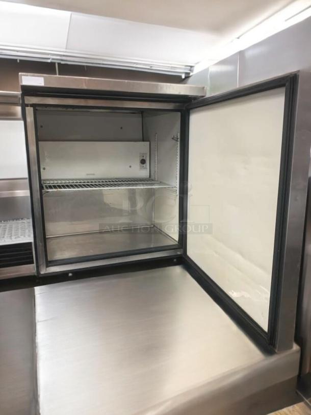 True TUC-27-LP undercounter refrigerator, prime condition, stainless steel, single door open showing interior and shelf.