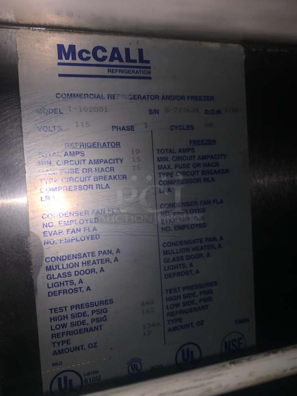 McCall 1-102001 commercial refrigerator/freezer label showing model, voltage, amps, and UL/NSF certifications.
