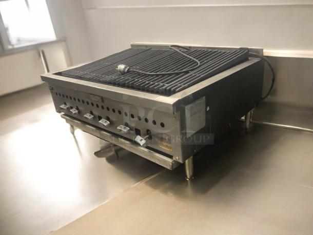 Commercial countertop charbroiler, stainless steel, heavy-duty gas grill, superb condition, multiple control knobs, fully tested.