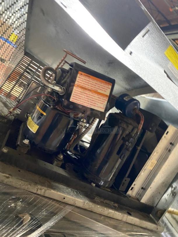 Norlake walk-in freezer compressor, Model CPF100DC-A, with visible labels. Includes self-contained blower, 208/230V, 1 Phase.