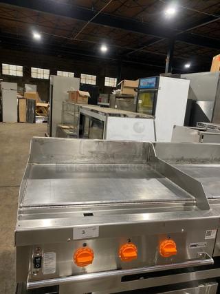 Woodstone 36" flat griddle, model WSGPL3636CT01NG, stainless steel, natural gas, with back and side splashes, on legs.