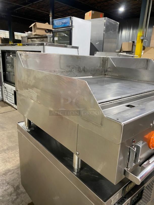 Woodstone 36" flat griddle, model WSGPL3636CT01NG, stainless steel, with back and side splashes, on legs, natural gas powered.