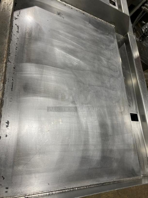 Woodstone 36" flat griddle/plancha, model WSGPL3636CT01NG, stainless steel, with back and side splashes, on legs.