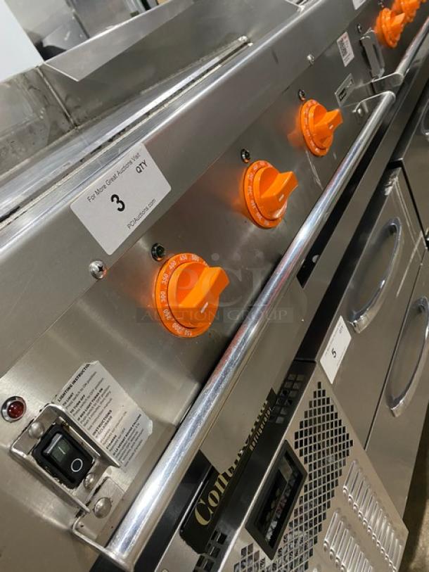 Woodstone 36" flat griddle, model WSGPL3636CT01NG, stainless steel, orange knobs, back and side splashes, on legs.