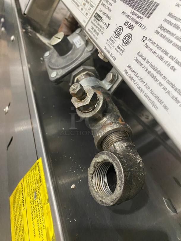 Woodstone gas-powered 36" griddle model WSGPL3636CT01NG, stainless steel, visible valve and label, in good condition.