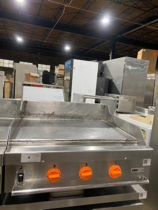 Woodstone WSGPL3636CT01NG 36" stainless steel flat griddle, natural gas, with back and side splashes. Model and serial labels visible.
