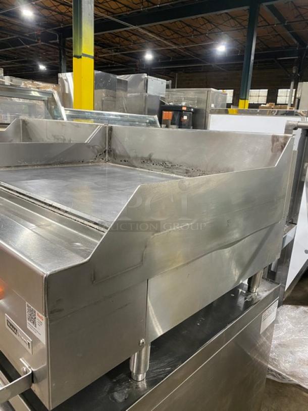 Woodstone 36" flat griddle, model WSGPL3636CT01NG, stainless steel, natural gas, with back and side splashes, on legs.