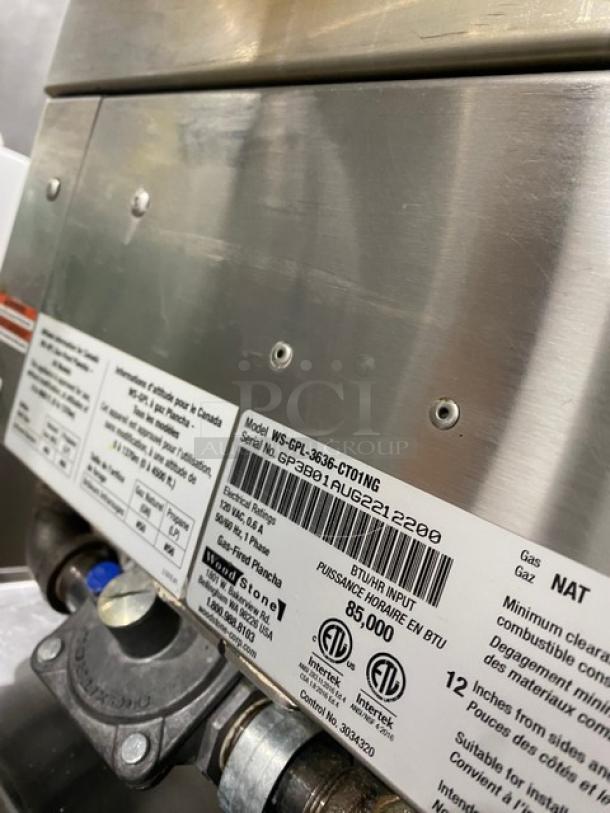 Woodstone commercial griddle Model WSGPL3636CT01NG with visible labels, stainless steel, 36", natural gas, on legs.