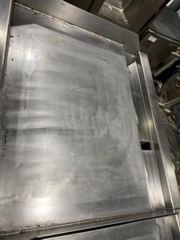 Woodstone 36" flat griddle, Model WSGPL3636CT01NG, stainless steel, with back and side splashes, natural gas, on legs.