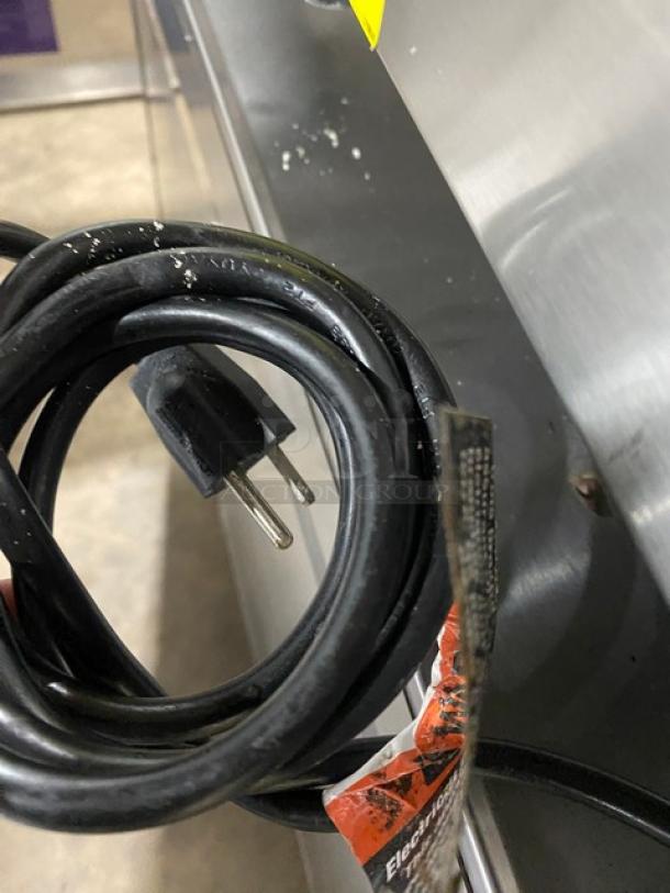 Woodstone 36" stainless steel flat griddle, model WSGPL3636CT01NG, features natural gas power, back and side splashes, on legs.