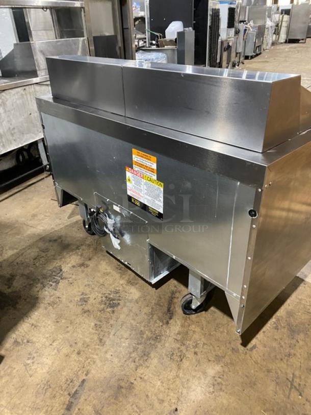 Welbilt/Delfield D4460NP-24M refrigerated prep table, stainless steel, 4 drawers, commercial cutting board, on casters.