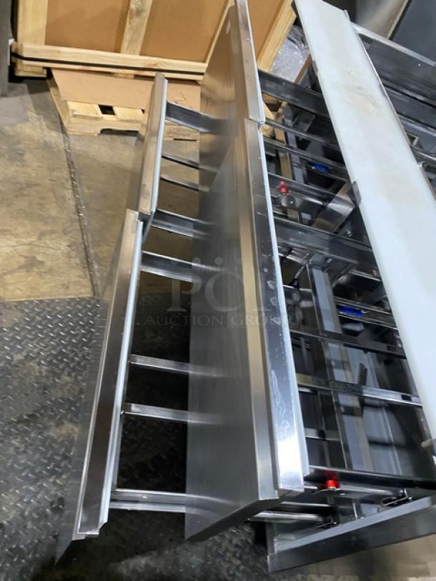 Welbilt/Delfield D4460NP-24M commercial refrigerated prep table, stainless steel, with 4 drawers and cutting board, on casters.