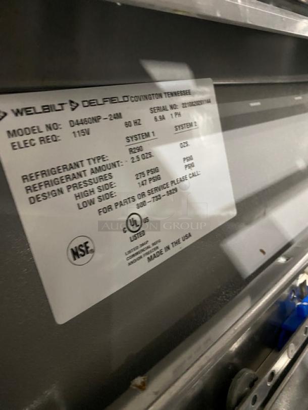 Welbilt/Delfield refrigerated prep table, model D4460NP-24M. Features stainless steel build, 4 drawers, and commercial casters.