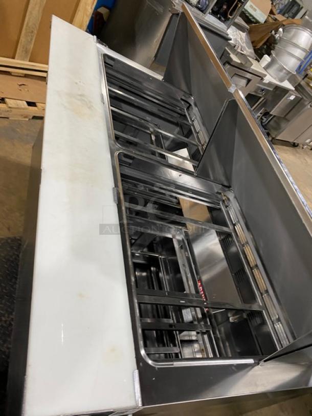 Welbilt/Delfield refrigerated prep table, model D4460NP-24M. Stainless steel, 4 drawers, cutting board, on casters.