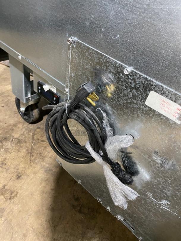 Welbilt/Delfield commercial prep table, Model D4460NP-24M, stainless steel with 4 drawers, cutting board, on casters.