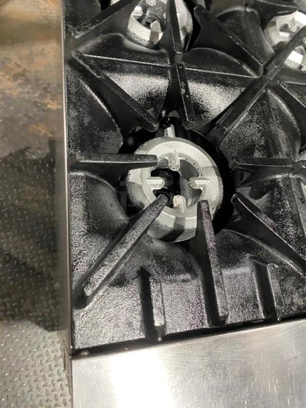 Sunfire X366R 6-burner range/oven combo detail showing cast iron burner grates, stainless steel surface, commercial-grade.