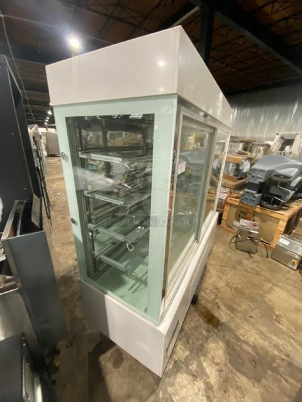 Commercial 5-tier refrigerated display case, model ZSGLLQ18, with glass showcase and two sliding doors, in good condition.
