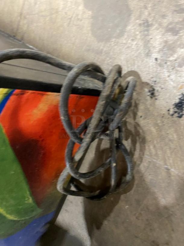 Coiled power cable on colorful surface, possibly part of a Habco refrigerator merchandiser. Condition not fully visible.