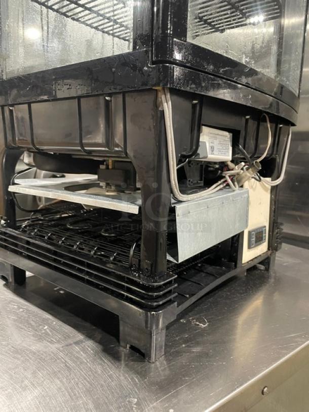 Winco CRD1K refrigerated display case, glass showcase style, model CRD1K, 110/120V, visible wiring, sturdy metal base.