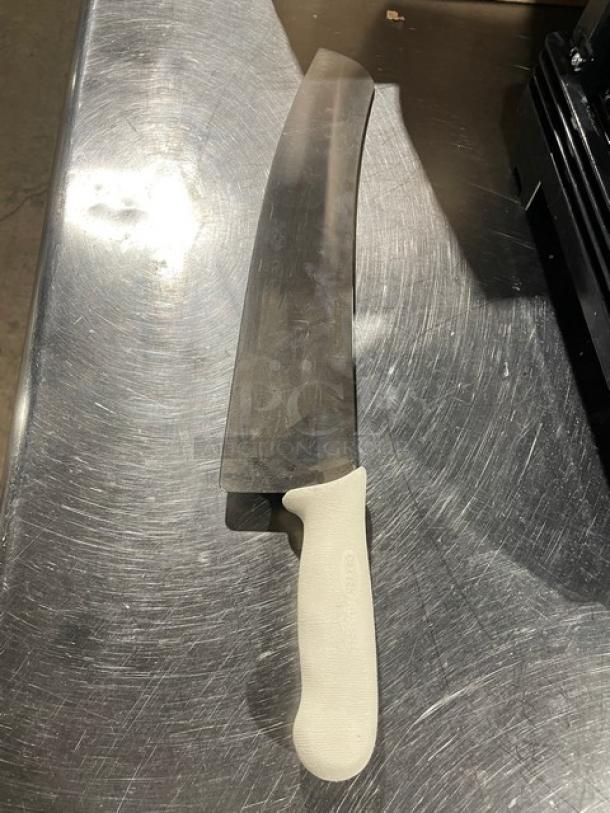 Dexter S16016 16" carbon steel pizza knife with white handle on metal surface, new condition.