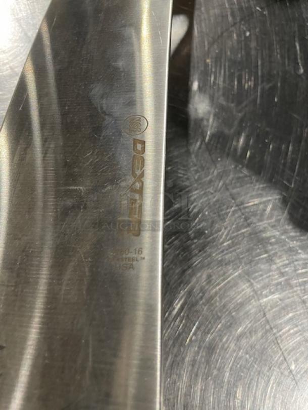 Dexter S16016 16" carbon steel pizza knife, brand new condition, etched branding and model details visible on blade.