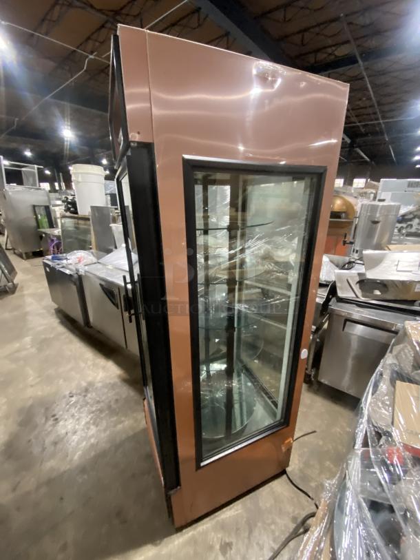 True commercial bakery display merchandiser, model G4SM-23RGS, with 4-sided glass and rotating shelves. One shelf broken.