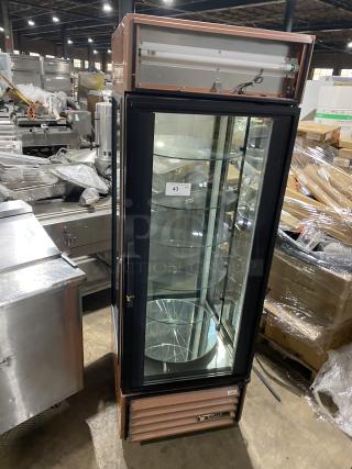 True Commercial Electric Bakery Display Merchandiser, Model G4SM-23RGS, with rotating glass shelves; one shelf broken.
