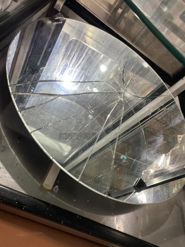 True G4SM-23RGS refrigerated bakery display with 4-sided glass, rotating shelves. One shelf is broken. Model: G4SM-23RGS.