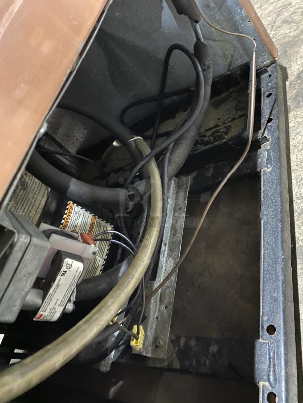 Interior view of True Commercial Refrigerated Bakery Display, Model G4SM-23RGS, showing wiring and components. One shelf broken.